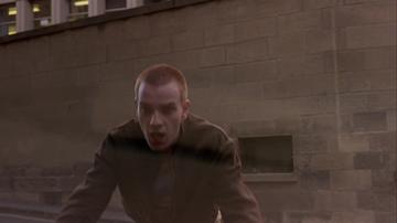 Trainspotting_Renton is nearly hit by a car