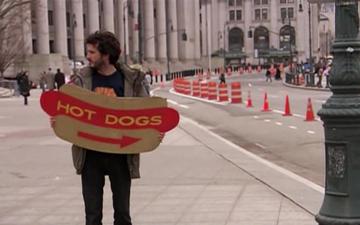 Flight of The Conchords_Bret holds his hot dog sign