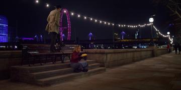 Last Christmas_Kate has a burger by the bench