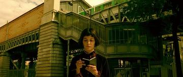 Amelie_Amelie checks her book outside the metro station